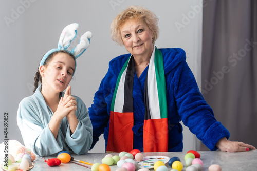 grandmother and granddaughter with uae flag for easter photo