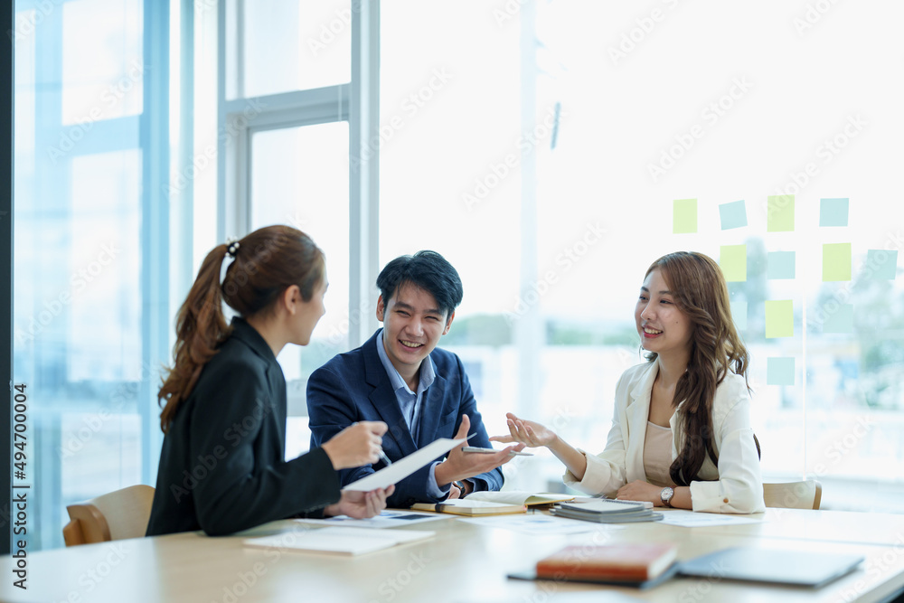 Happy group of business asian work cooperate with diverse team at office briefing, focused biracial businessman head meeting, collaborate discuss business ideas with colleagues at meeting Happy group of business asian work cooperate with diverse team at office briefing, focused biracial businessman head meeting, collaborate discuss business ideas with colleagues at meeting