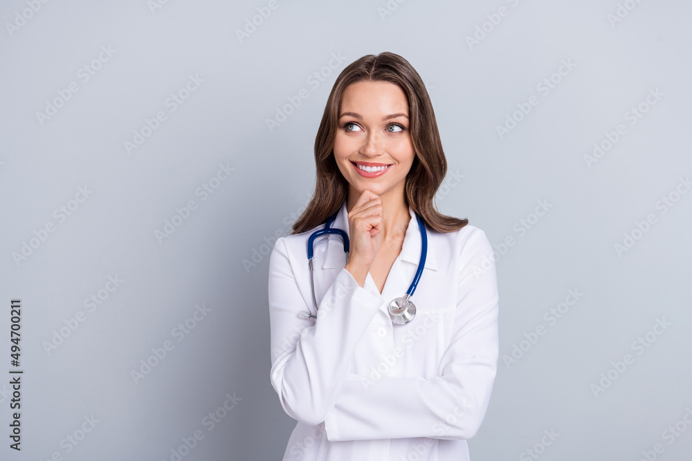 Photo of minded virologist lady look empty space think new covid protection prescription isolated grey color background Photo of minded virologist lady look empty space think new covid protection prescription isolated grey color background