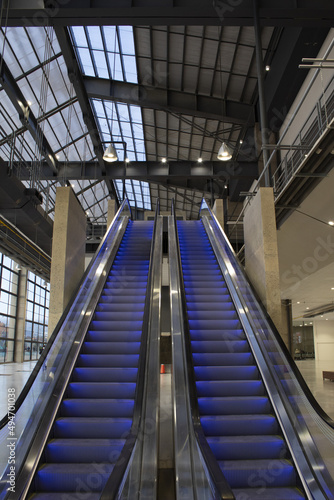escalators with blue neon light with gray perspective and top view