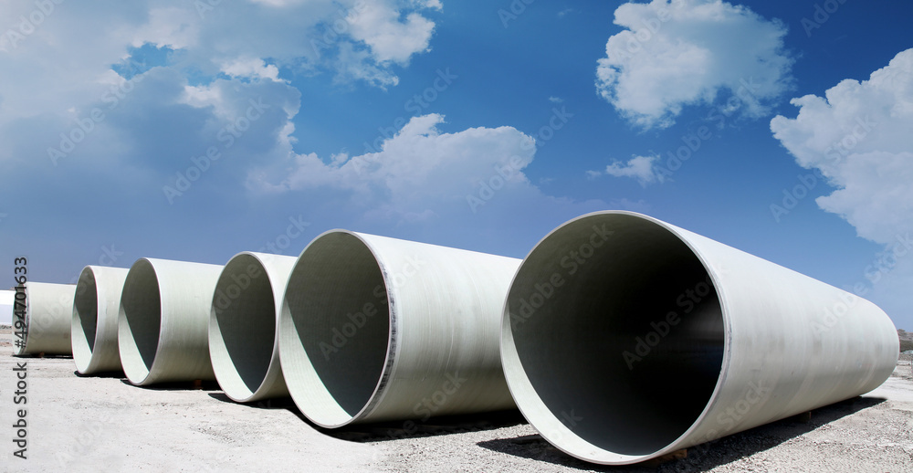 Massive hydroelectric pipelines converge up a hill Massive hydroelectric pipelines converge up a hill
