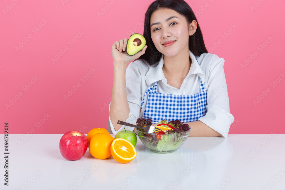 happy young asian woman choose to eat fresh orange apple fruits with copy space pink background, health care eat vegetables and useful foods lifestyles concept. happy young asian woman choose to eat fresh orange apple fruits with copy space pink background, health care eat vegetables and useful foods lifestyles concept.