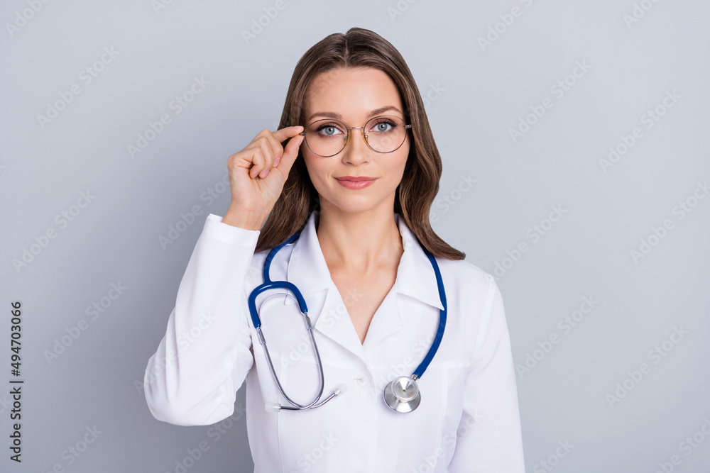 Portrait of calm confident person arm touch spectacles look camera isolated on grey color background Portrait of calm confident person arm touch spectacles look camera isolated on grey color background