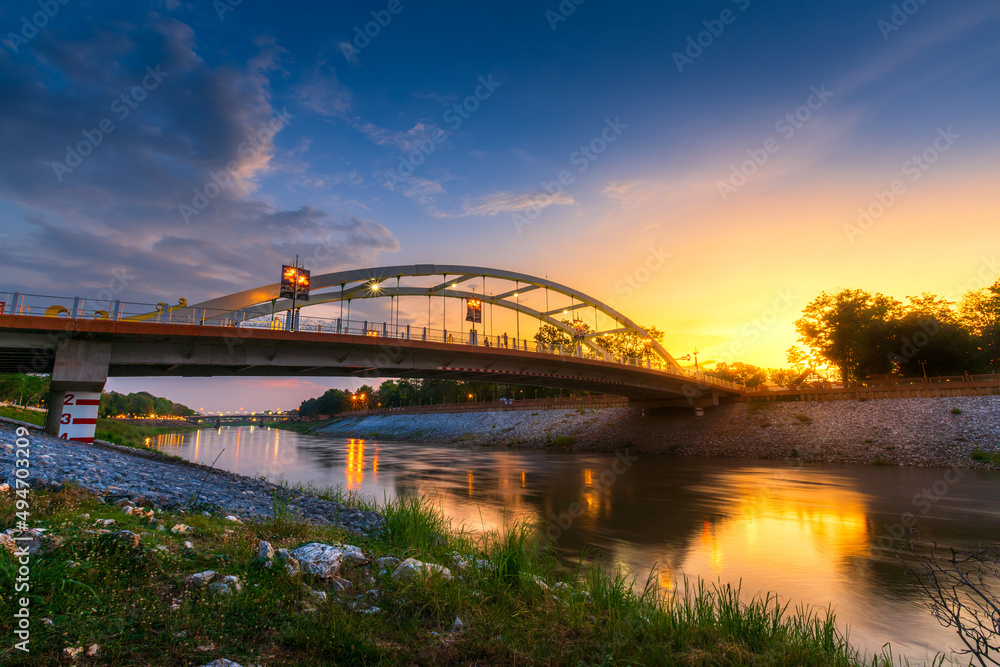 light Bridge over the Nan River (Chan Palace bridge ) New Landmark It is a major tourist is Public places attraction Phitsanulok,Thailand.vivid Twilight dramatic sunset. light Bridge over the Nan River (Chan Palace bridge ) New Landmark It is a major tourist is Public places attraction Phitsanulok,Thailand.vivid Twilight dramatic sunset.
