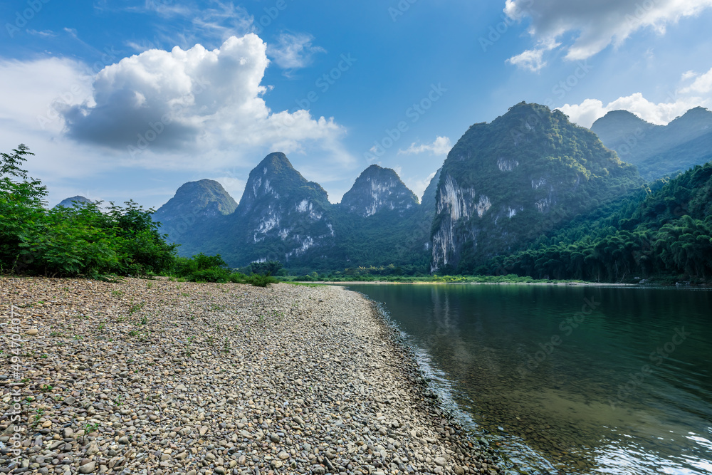 Beautiful mountains and pebble beach with river in Guilin at sunrise, China.