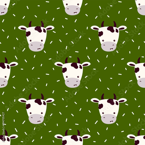 Vector seamless pattern with muzzles of cows on a green background