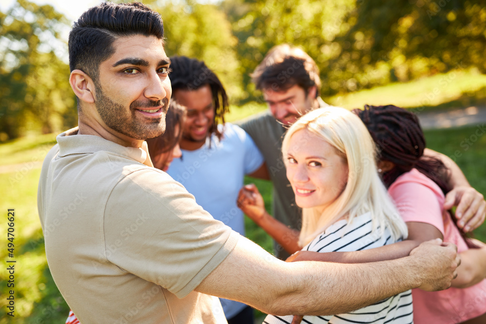 Young people embrace as a community in a circle Young people embrace as a community in a circle