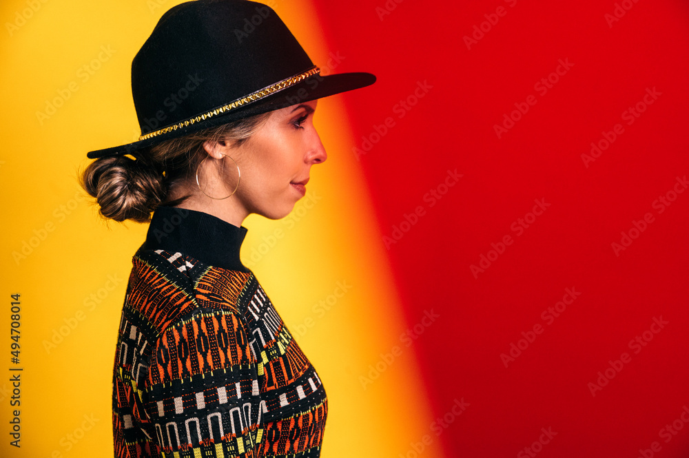 Woman in trendy hat in studio