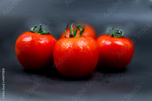 Fresh Red Tomatoes on a dark background. Red Tomatoes and Black Background 