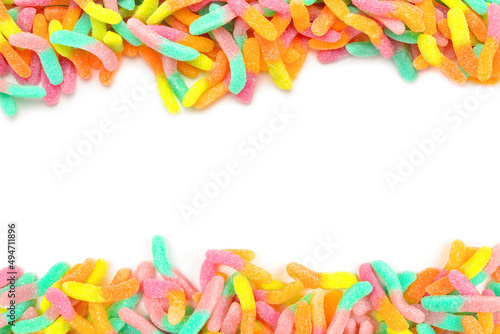 Frame of colorful gummy candies isolated on white. Top view. Space for text or design.