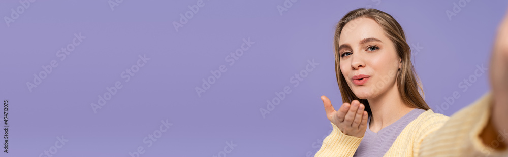young woman sending air kiss isolated on purple, banner. young woman sending air kiss isolated on purple, banner.