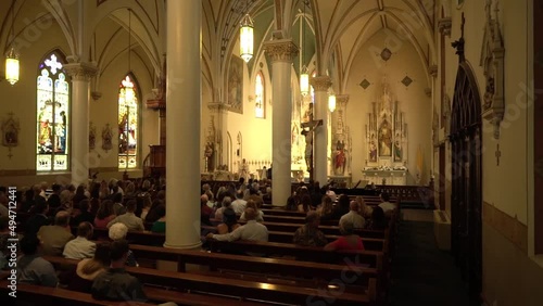 People gather in a church for a wedding.