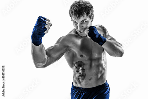 Portrait of silhouette boxer who training, practicing uppercut on white background. Blue sportswear photo