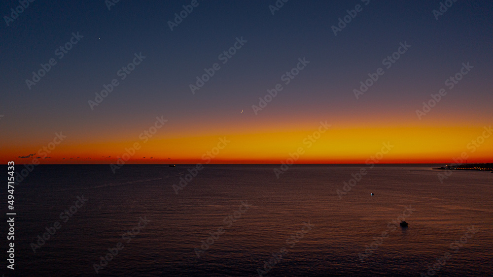 Obraz premium huge sunset with a golden hour over sea from sky