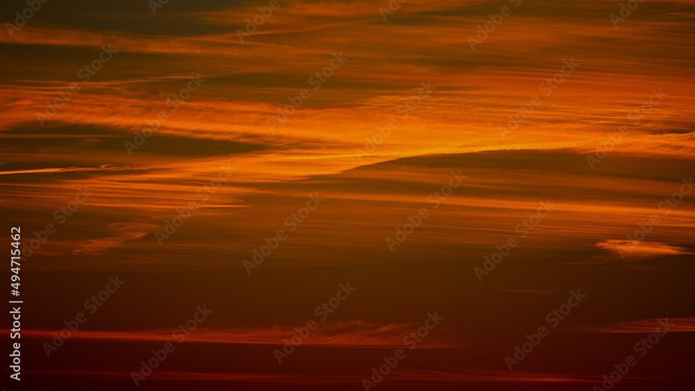 orange and golden sky with great lines in the horizon