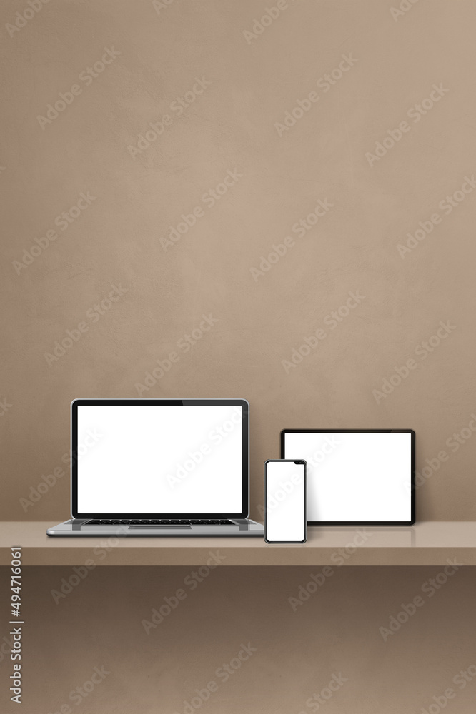 Laptop, mobile phone and digital tablet pc on brown wall shelf. Vertical background Laptop, mobile phone and digital tablet pc on brown wall shelf. Vertical background