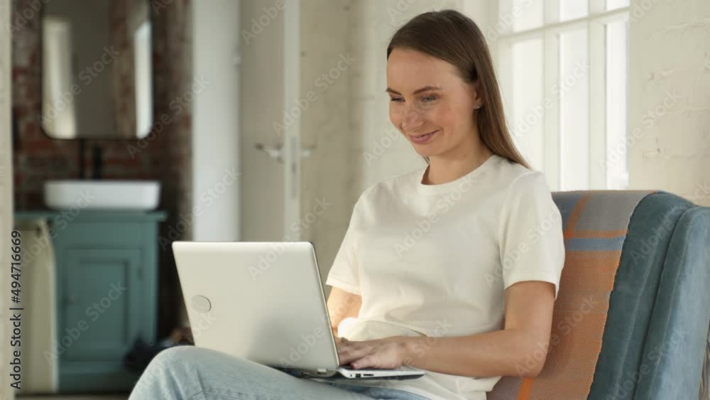 Beautiful young woman working on a laptop in a home interior. Freelancer A modern business woman uses a laptop for remote work or online shopping. Beautiful young woman working on a laptop in a home interior. Freelancer A modern business woman uses a laptop for remote work or online shopping.