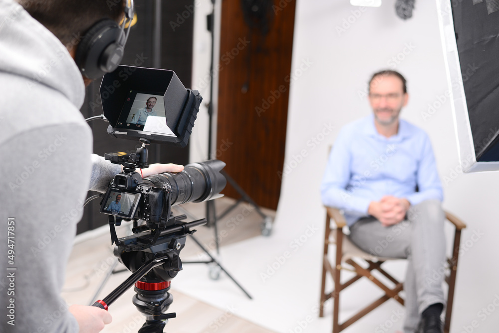 young man video camera operator making interview in professionnal broadcast tv movie studio film production young man video camera operator making interview in professionnal broadcast tv movie studio film production