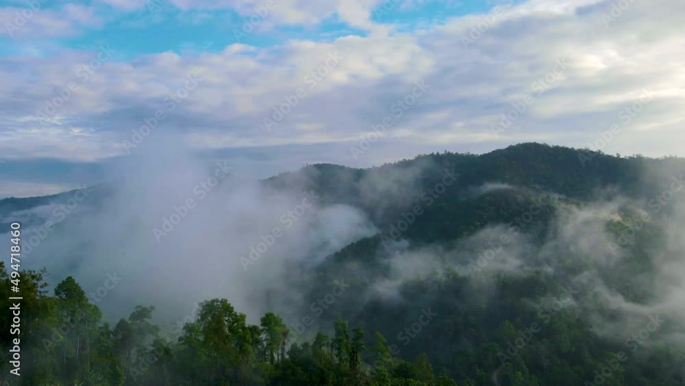 Hyper lapse aerial view from drone mountain peak with green trees in fog Hyper lapse aerial view from drone mountain peak with green trees in fog