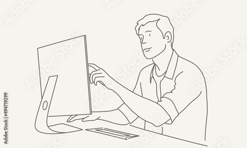 Man working on project. He is looking at the laptop screen.