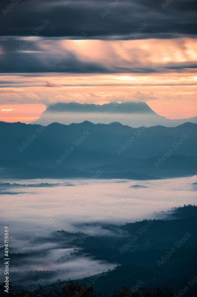 Beautiful sunrise over mountain with Doi Luang Chiang Dao peak and foggy in the valley at national park