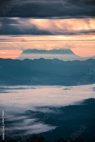 Beautiful sunrise over mountain with Doi Luang Chiang Dao peak and foggy in the valley at national park