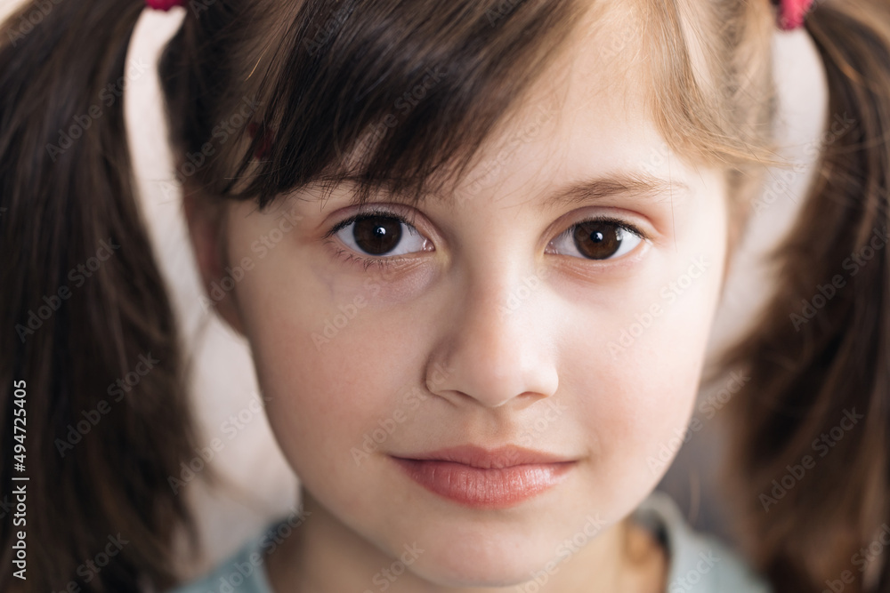 Close-up face portrait of a beautiful little girl. Caucasian little girl looking at the camera. Happy childhood concept. Close-up face portrait of a beautiful little girl. Caucasian little girl looking at the camera. Happy childhood concept.