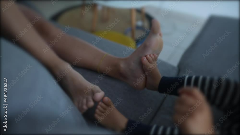Mother and child son bonding moment putting feet together Mother and child son bonding moment putting feet together