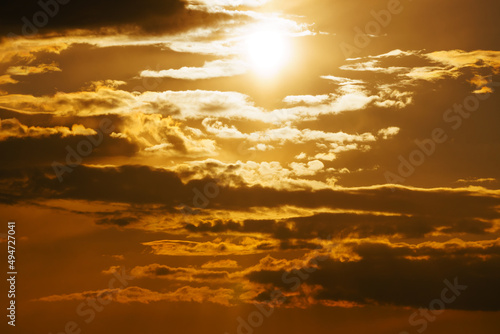 beautiful sunset sky, bright sunlight and dark silhouette of clouds as background