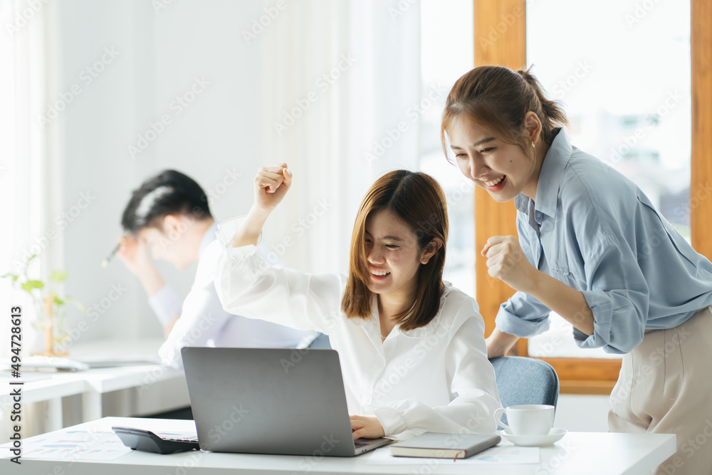 2 businesswomen working on line watching webs in a laptop in a bar with a window and and outdoors in the background 2 businesswomen working on line watching webs in a laptop in a bar with a window and and outdoors in the background