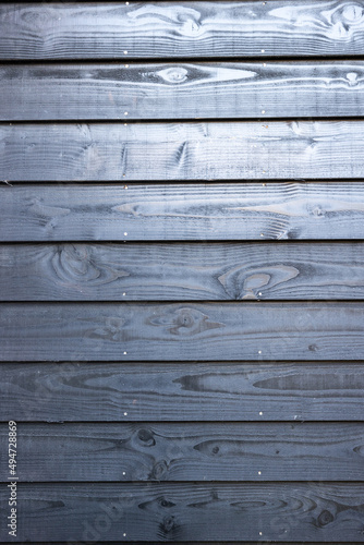 Black wooden fence in yard