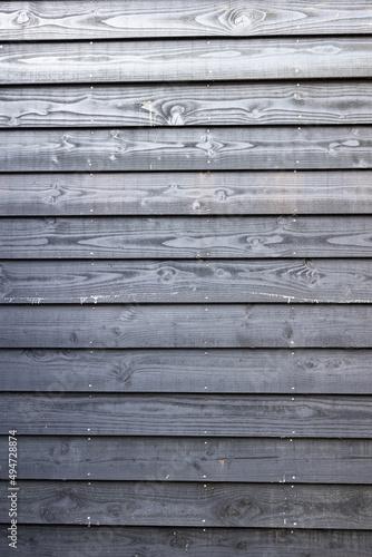 Black wooden fence in yard