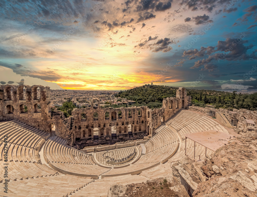 Fiery sky over Herodion ancient theater and Athens city panoramic view during sunrise, Greece