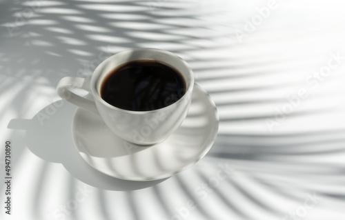 Hot coffee (espresso coffee) on white background with palm leaves shadow. White on white and minimalist style.