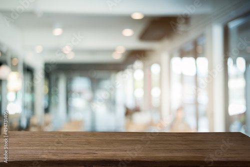 Abstract bokeh office blurred background with wood table.	