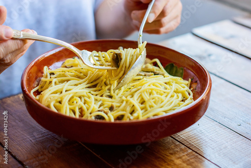 Woman eats Italian pasta at home