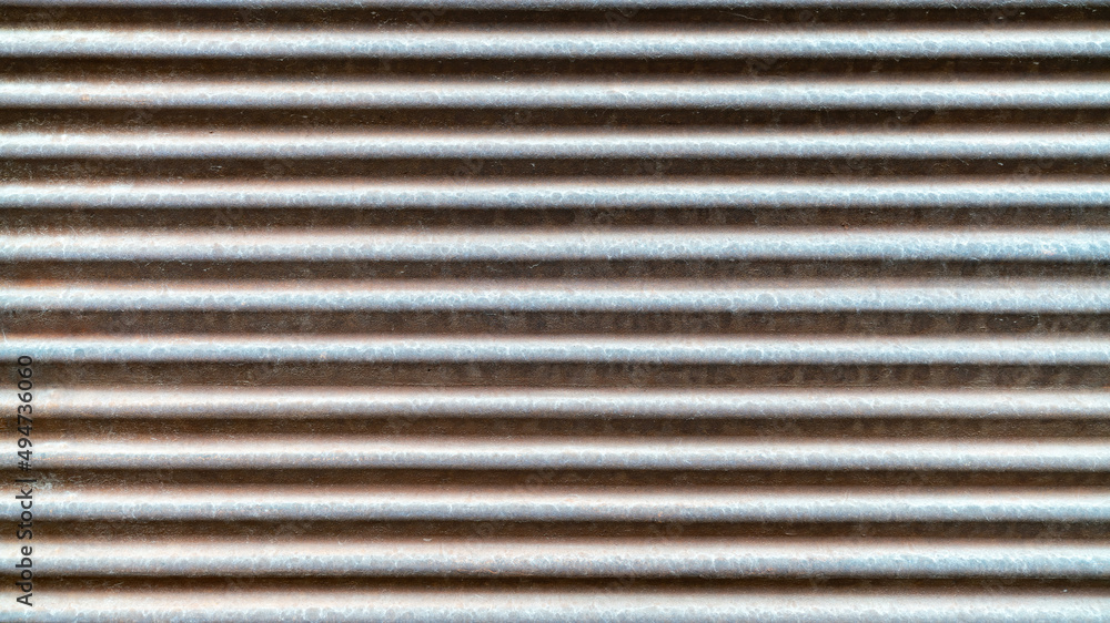 Gray metal shutters, real galvanized sheet metal texture, with deformations in the metal shutter surface Gray metal shutters, real galvanized sheet metal texture, with deformations in the metal shutter surface