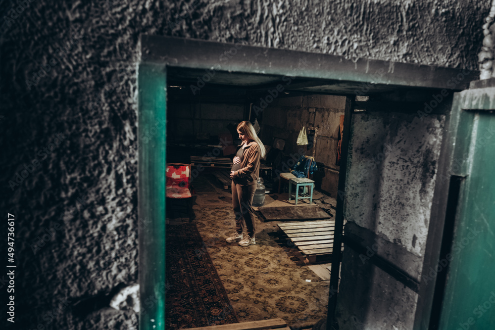 War in Ukraine. A Ukrainian pregnant woman hides in a bomb shelter while resisting a Russian invasion.