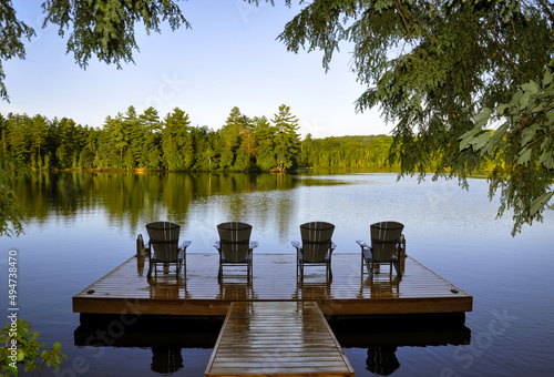 View of lake with chairs on the dock