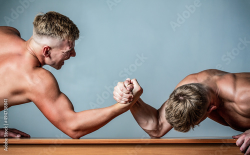 Two hands. Men measuring forces, arms. Hand wrestling, compete. Hands or arms of man. Arm wrestling. Two men arm wrestling. Rivalry, closeup of male arm wrestling photo
