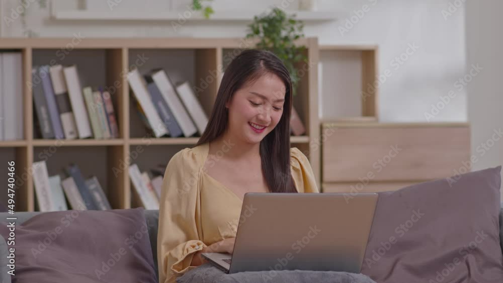 Energetic Asian girl working on laptop from home office. Female executive using computer remote studying, browsing web, having virtual meeting, typing on computer. New normal life style. Energetic Asian girl working on laptop from home office. Female executive using computer remote studying, browsing web, having virtual meeting, typing on computer. New normal life style.
