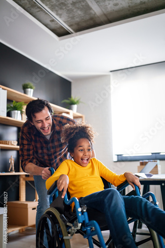Happy multiethnic family with child with disability in wheelchair