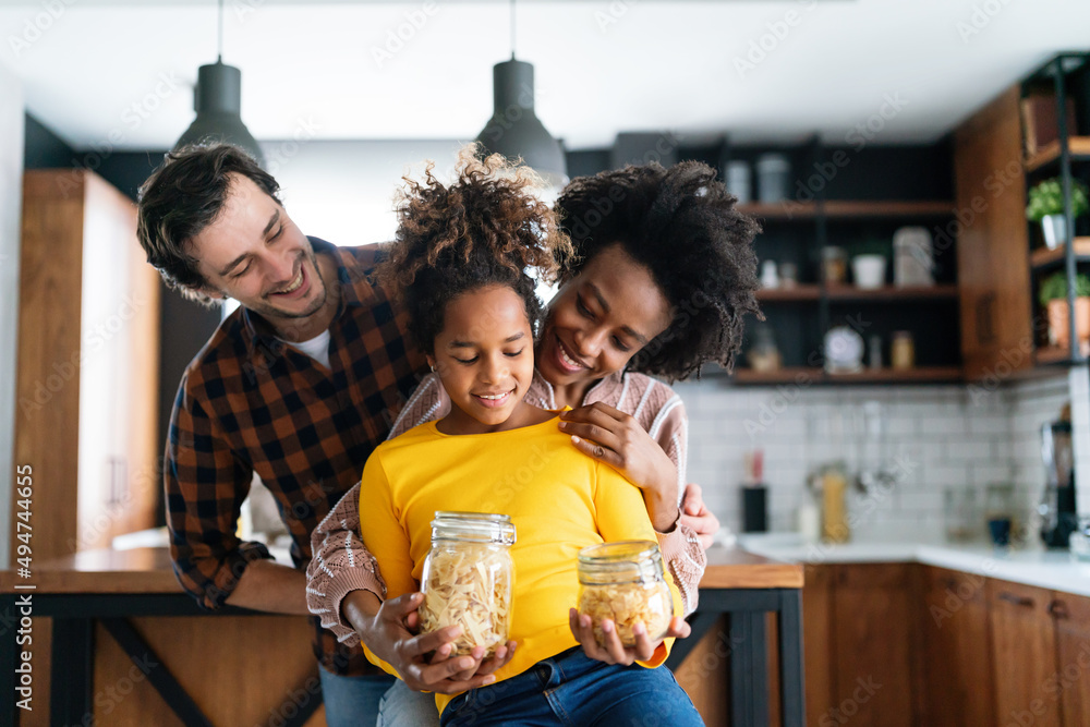 Happy multiethnic family in love together in kitchen. Parents child together concept Happy multiethnic family in love together in kitchen. Parents child together concept