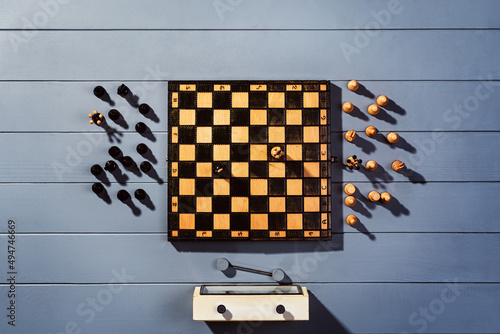 Top view on wooden chess board with figures during the game on gray wooden table background with copy space photo