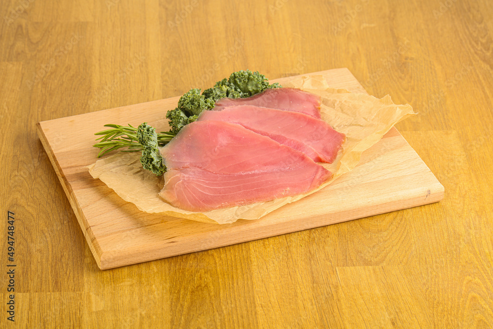 Raw salted tuna slice over board Raw salted tuna slice over board