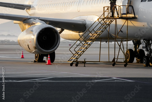 The plane in front of the airport terminal at sunrise