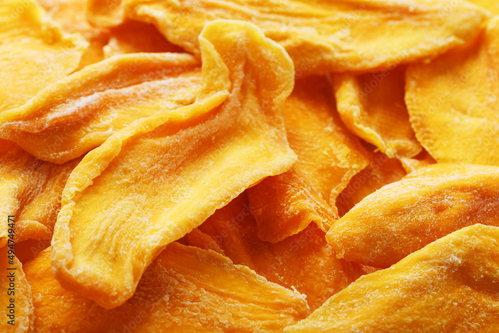 Pieces of sweet dried mango close-up as a background in full screen Pieces of sweet dried mango close-up as a background in full screen