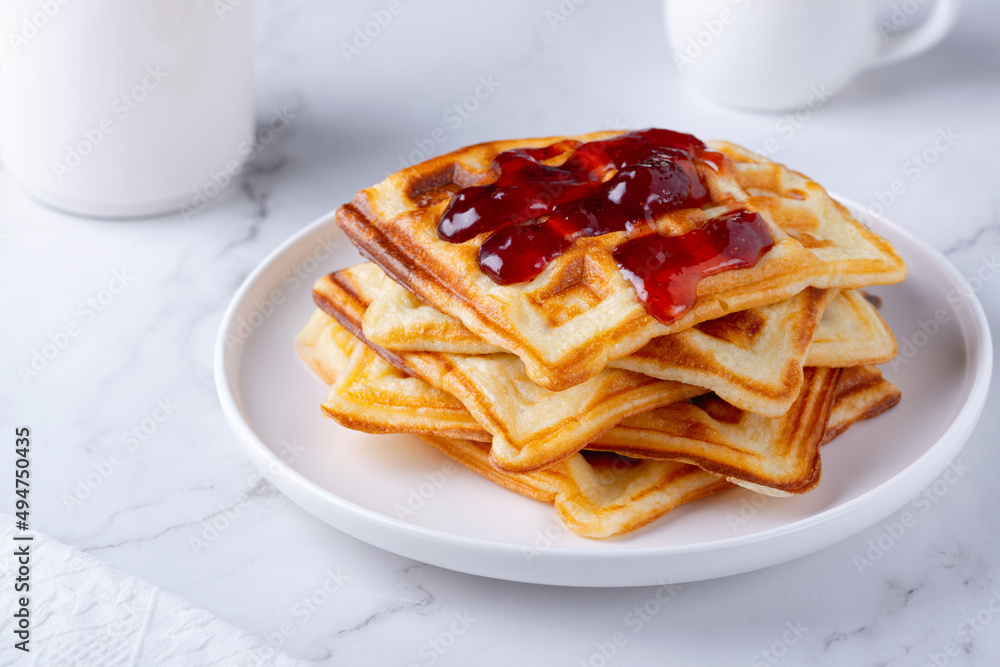 Homemade delicious belgian waffles on the white table Homemade delicious belgian waffles on the white table