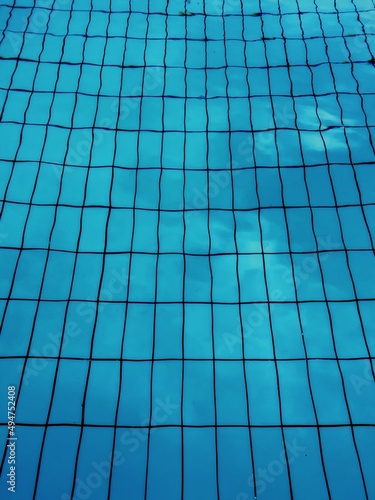 swimming pool water blue checkered tiles sky reflection