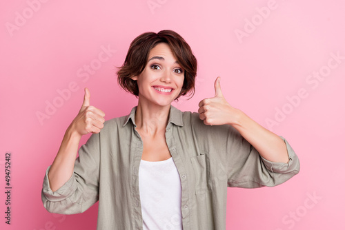Photo of positive attractive lady show thumb up symbol suggest perfect shopping offer isolated over pastel color background photo